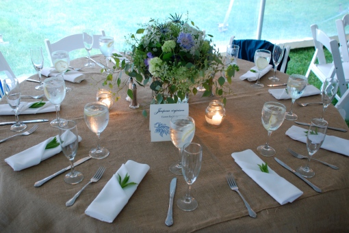 Centerpieces with table settings We tucked mint into each napkin and placed