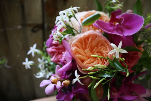 Bride's Bouquet with peach garden roses, phalenopsis orchids, and jasmine.